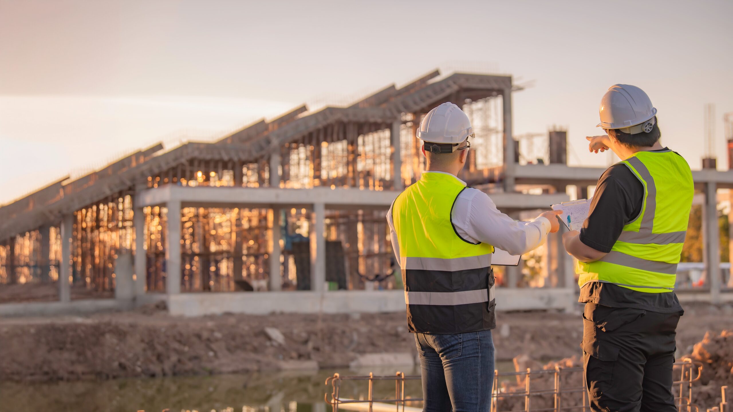 two industrial engineers looking at construction project