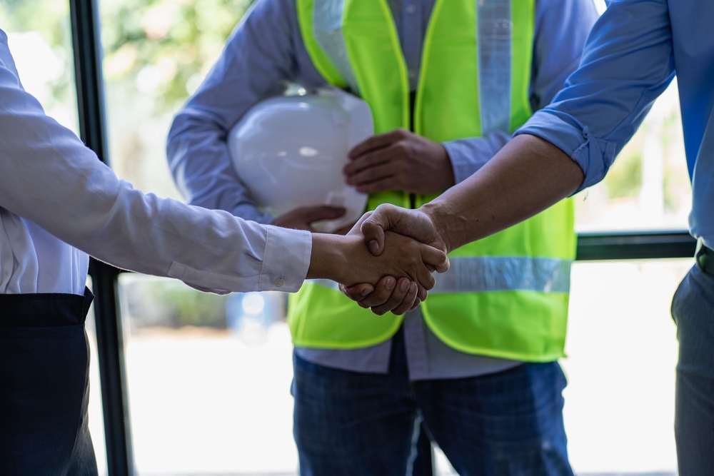 construction workers shaking hands